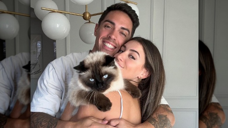 John and Jessie Pearce snuggling with cat