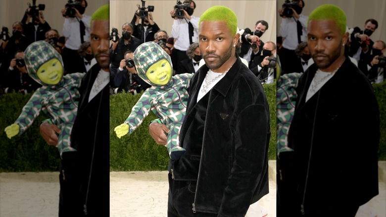 Frank Ocean holding a robot baby at the 2021 Met Gala.