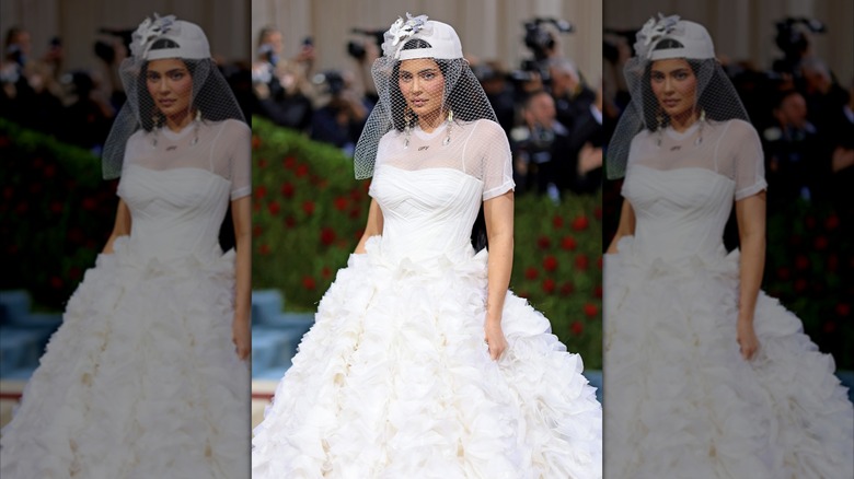 Kylie Jenner wearing a baseball hat and a bridal dress at the 2022 Met Gala.