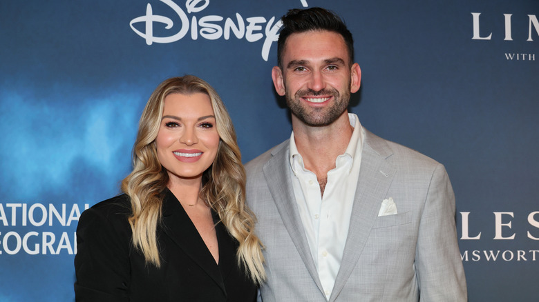 Carl Radke and Lindsay Hubbard smile on the red carpet
