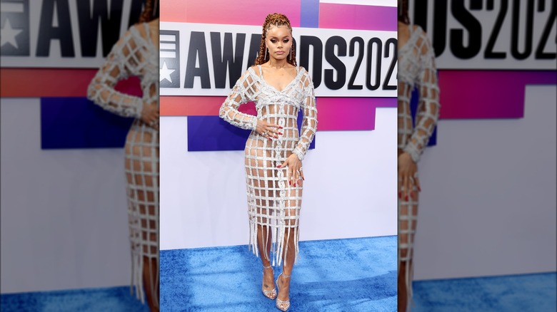Andra Day posing in white