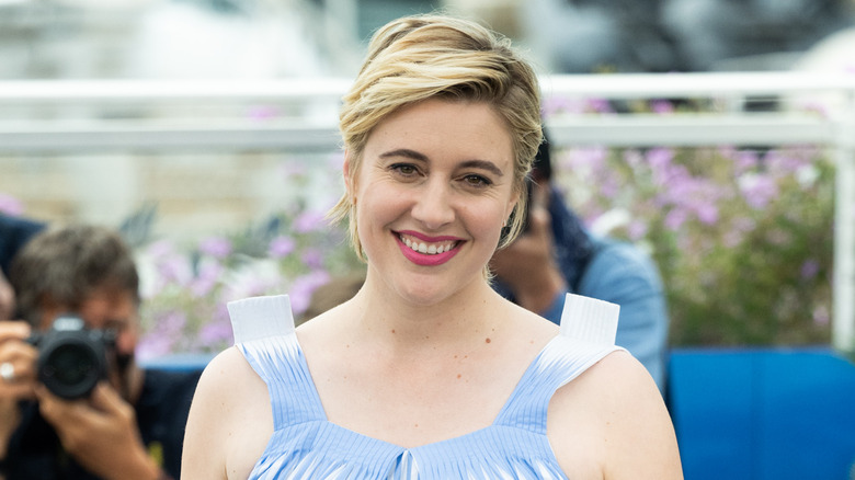 Greta Gerwig smiling outdoors