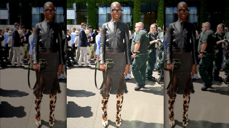 Leomie Anderson wearing black leather coat and cow-print boots at Wimbledon 2025