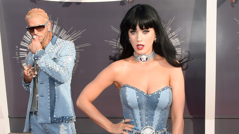 Riff Raff looking at Katy Perry while both wear bedazzled denim outfits.