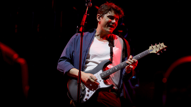John Mayer in a blue shirt with white undershirt