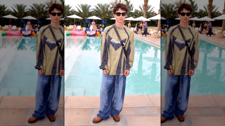 Troye Sivan in baggy jeans, shirt, and sunglasses