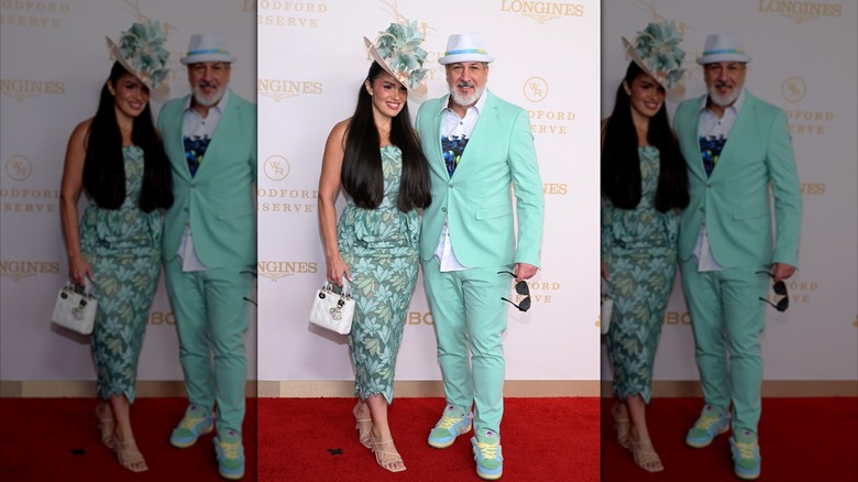 At the Kentucky Derby, Joey Fatone wears a mint suit and poses with his wife Kelly Baldwin, who wears a matching floral dress and hat.