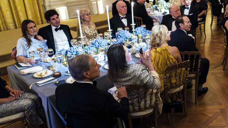 Cecilia Abbott taking a video during a performance at the 2026 Governors Dinner