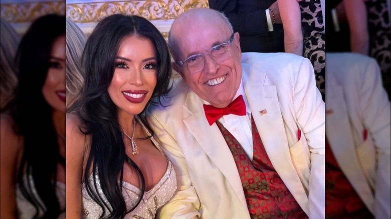 Rudy Giuliani poses with a woman at Trump's Mar-a-Lago New Year's Eve party.