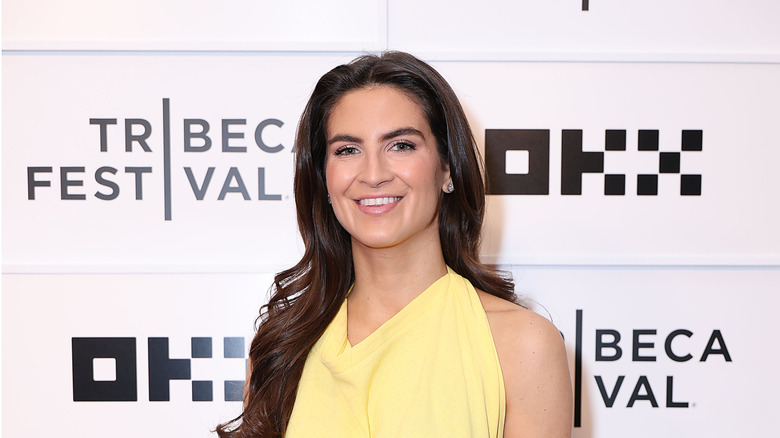 Kaitlan Collins smiling on the red carpet in a yellow dress