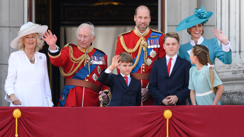 The British royal family waving to the public from the Buckingham Palace balcony