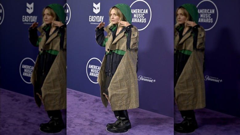 Dora Jar wearing a trench coat and galoshes on the AMAs red carpet
