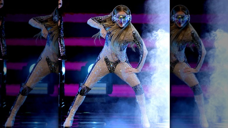 Jennifer Lopez wearing a nude bodysuit and mask during an AMAs performance