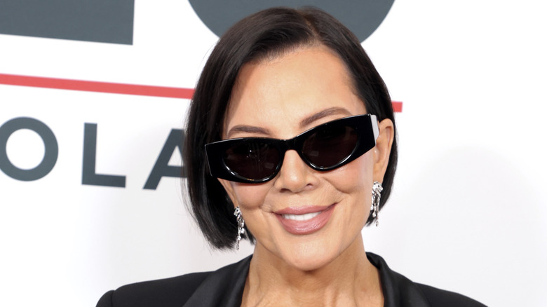 Kris Jenner wearing a black suit and sunglasses