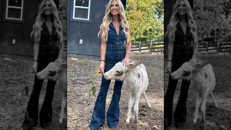 Christina Hall feeding a goat