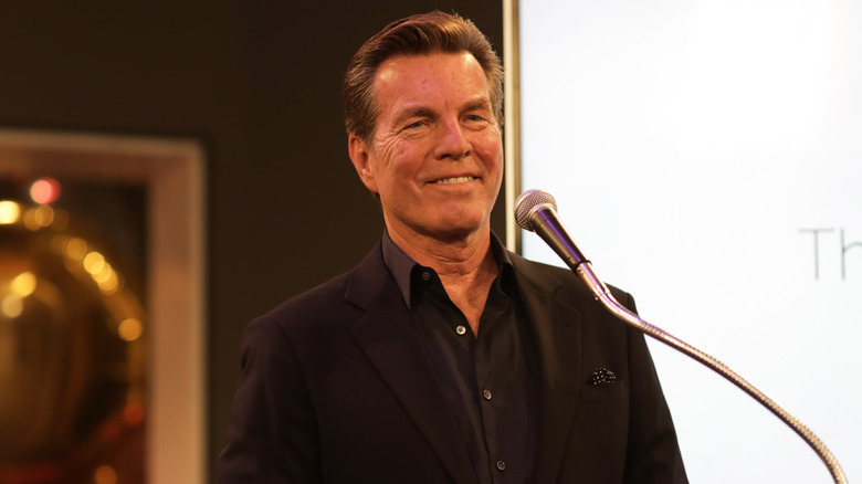 Peter Bergman standing at a microphone