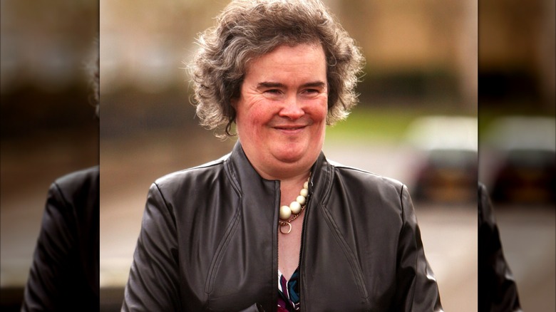 Susan Boyle wearing a black leather jacket and chunky beaded necklace.