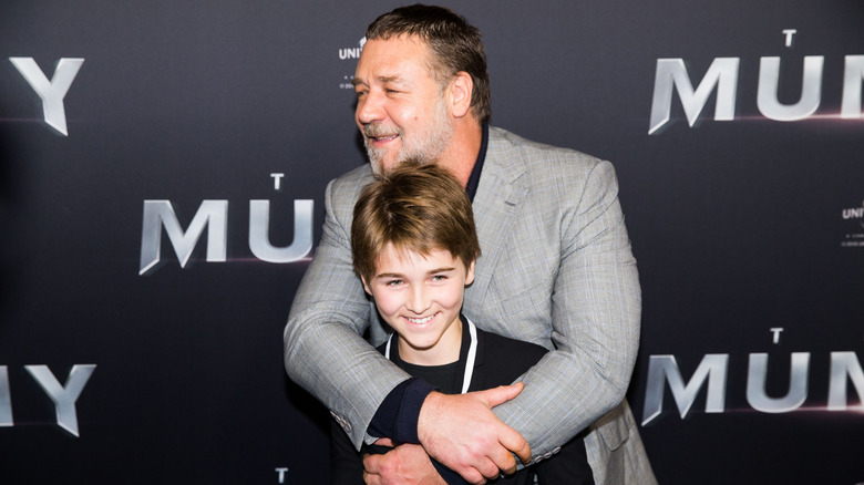 Russell Crowe hugging his son Tennyson Crowe on the red carpet.