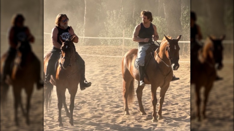 Russell Crowe and his son Tennyson Crowe speak to each other while on horseback.