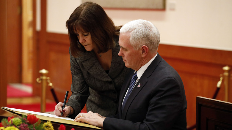 Mike and Karen Pence signing a guestbook.