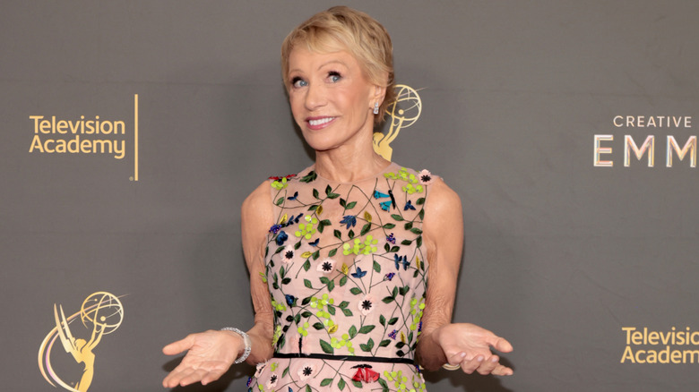Barbara Corcoran shrugging playfully on the red carpet at the Creative Arts Emmys.