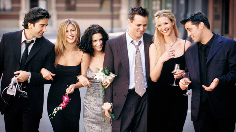 The cast of Friends wearing formalwear and flowers