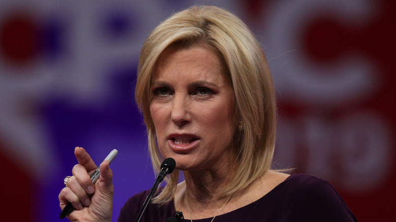 Laura Ingraham scowling while delivering a speech
