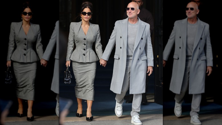 Dressed in matching gray looks, Lauren Sánchez and Jeff Bezos hold hands.