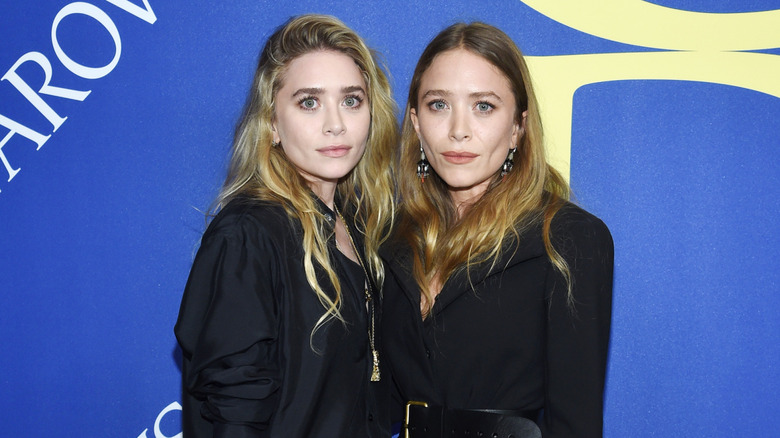 Mary-Kate Olsen and Ashley Olsen posing