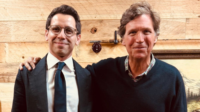 James Fishback and Tucker Carlson pose