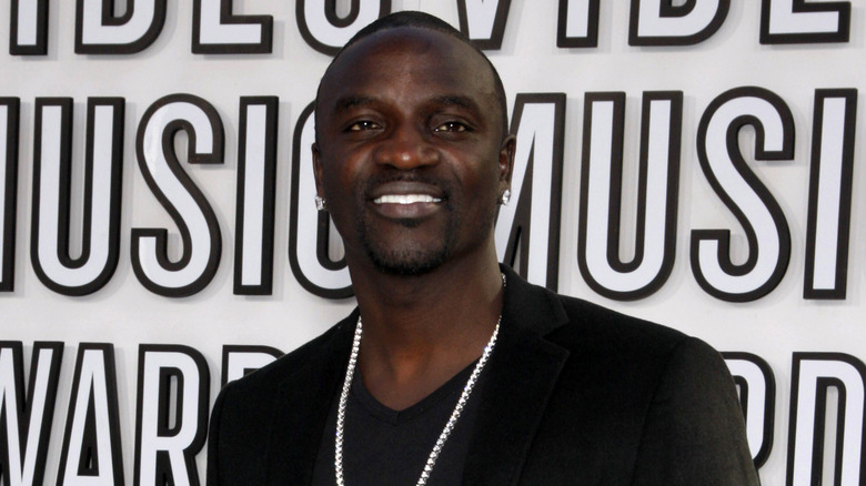 Akon smiling at an event 