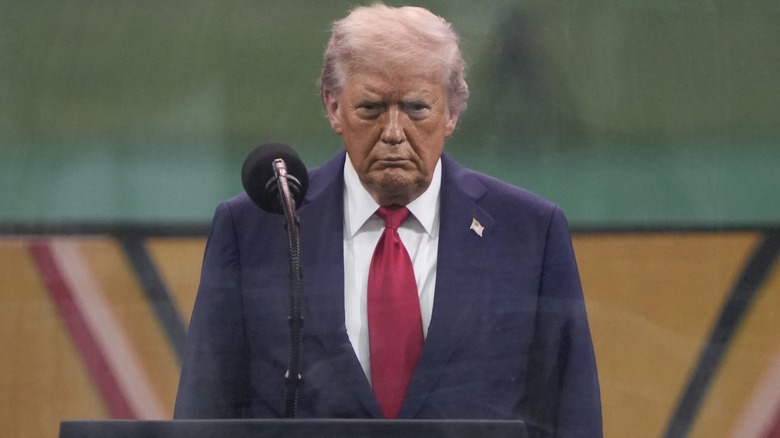Trump at podium of military parade looking angry