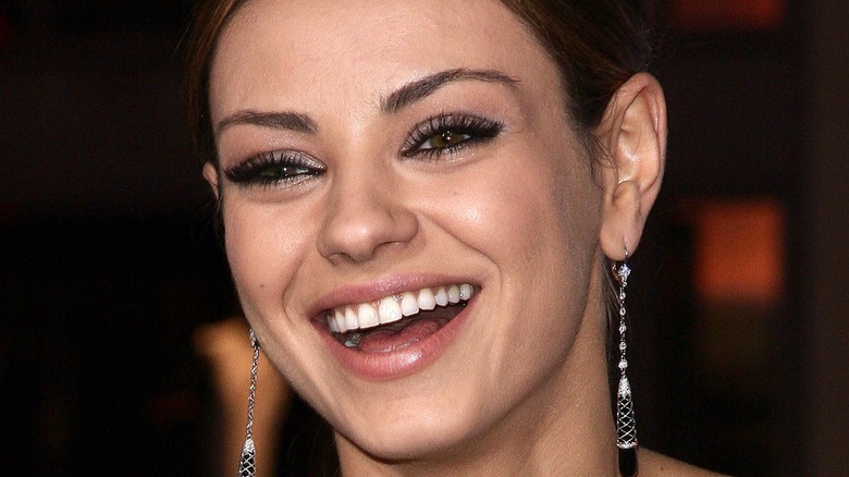 Mila Kunis laughing