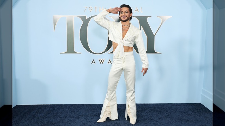 Frankie Grande posing at the 2026 Tony Awards in a white suit.