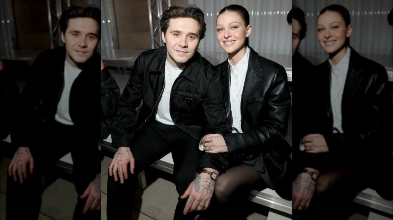 Brooklyn Beckham and Nicola Peltz sitting at a fashion show