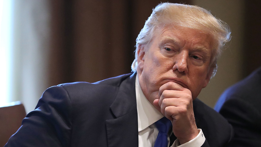 Trump resting chin on clenched fist 