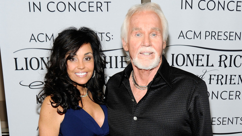 Kenny and wife Wanda Miller pose on a red carpet