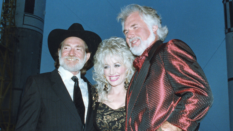 Kenny Rogers, Dolly Parton, and Willie Nelson pose together.