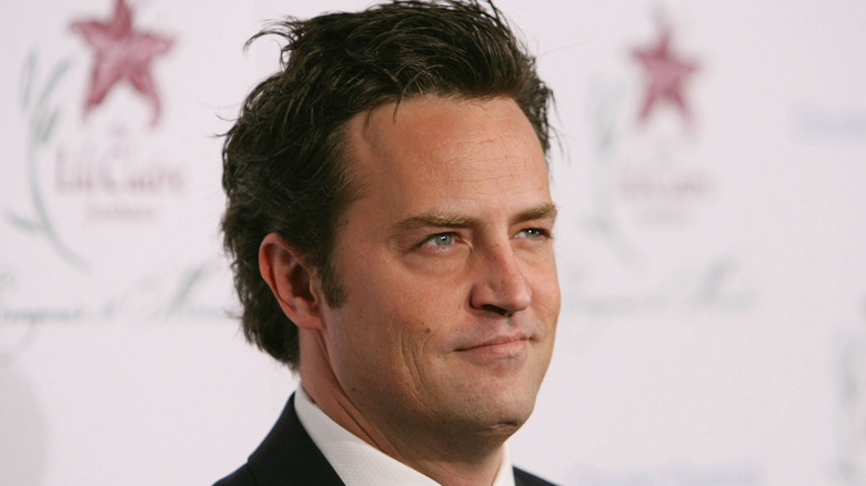 Matthew Perry at a red carpet event wearing a tuxedo