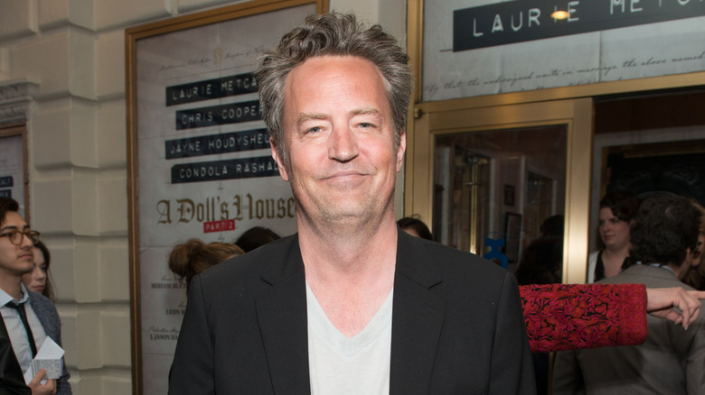 Matthew Perry at a Broadway premiere wearing a black blazer and grey t-shirt