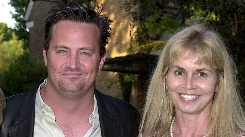 Matthew Perry wearing a black jacket and his mother Suzanne Morrison wearing a sleeveless dress and pearls