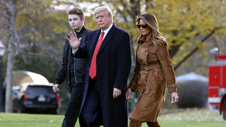 Barron Trump at an event walking with his parents