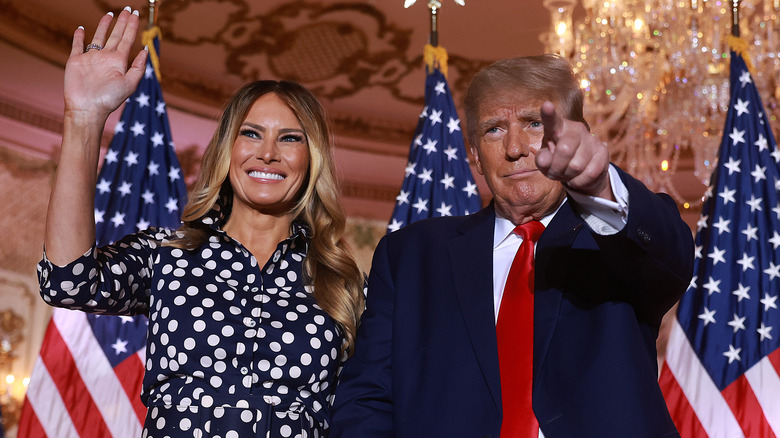 Melania Trump waving and Donald Trump pointing