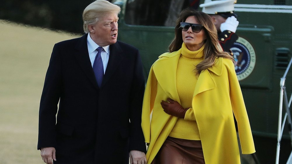 Donald and Melania Trump talking and walking