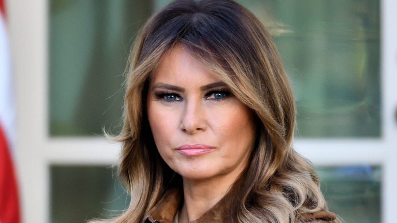 Melania Trump posing near the American flag