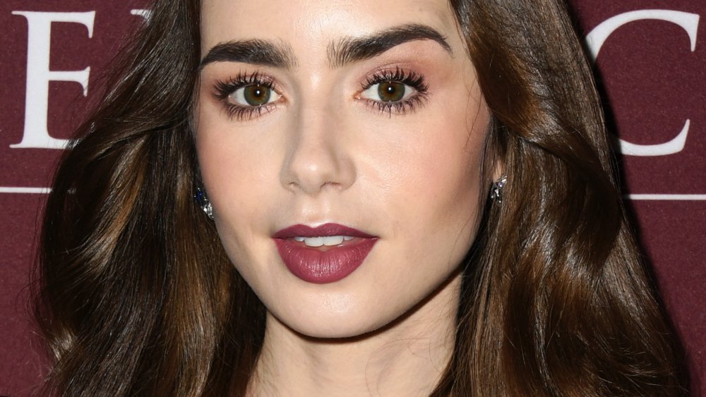 Lily Collins raising one eyebrow 