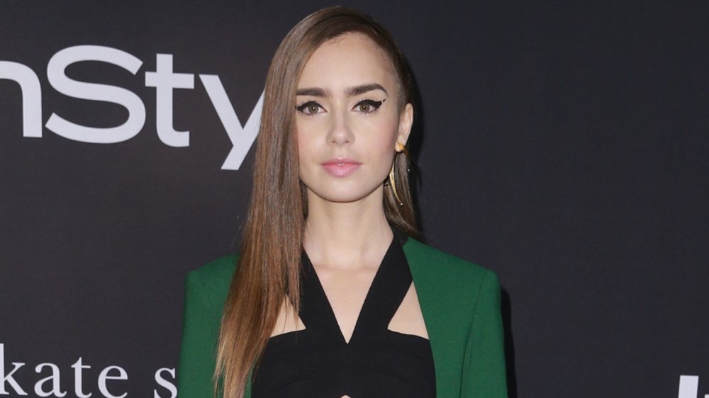 Lily Collins with a slight smile 