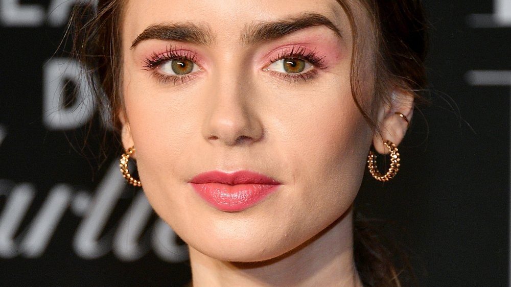 Lily Collins raising one eyebrow 