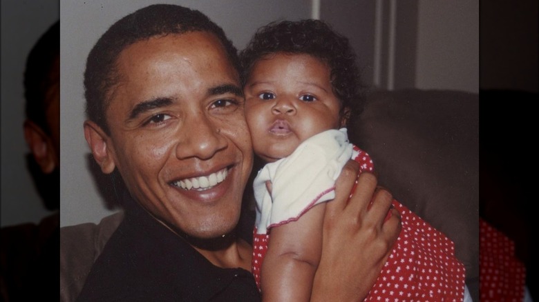 Barack Obama holding baby Sasha
