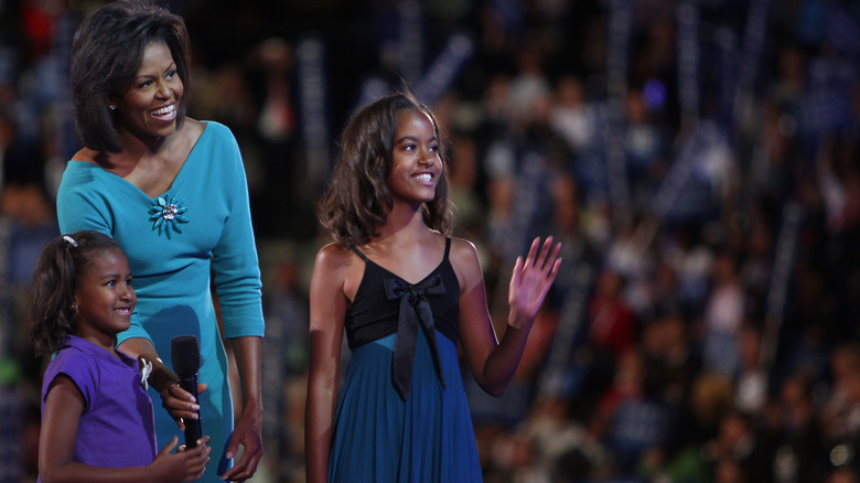 Sasha Obama, Michelle Obama, and Malia Obama on stage